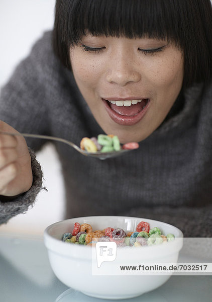 Mid-Adult Woman Eating Breakfast Cereals