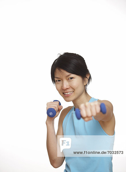 Mid-Adult Woman Working Out with Dumbbells