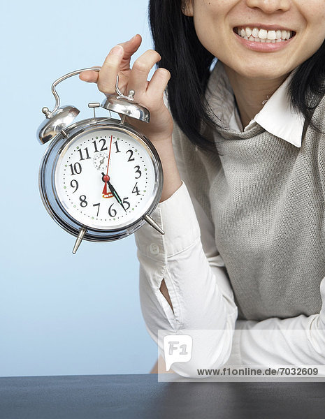 Close-Up of Businesswoman Holding Alarm Clock