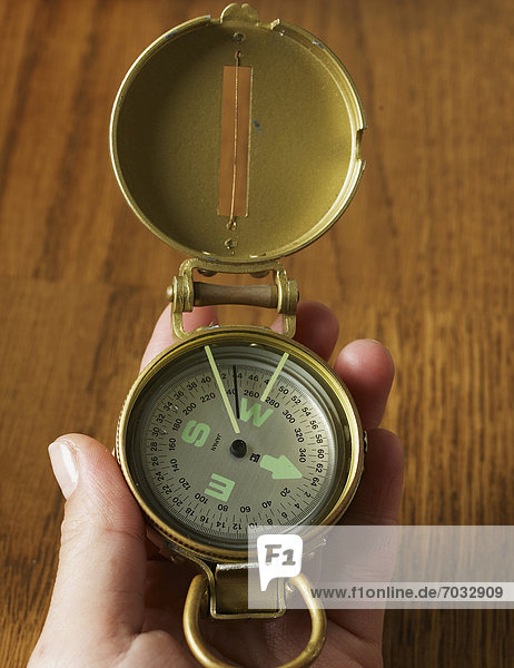 Person Holding Old-Fashioned Compass