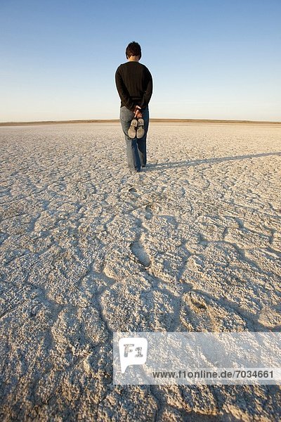 Rear View Of Woman Standing In Desert