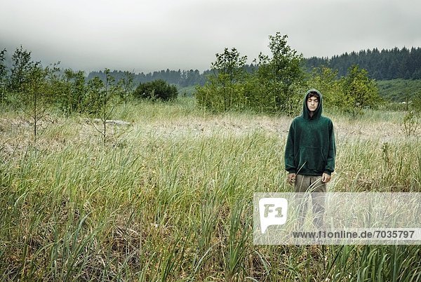 Person Standing In Field In The Rain