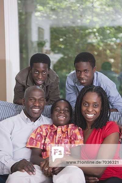Happy African American Family Together On The Couch
