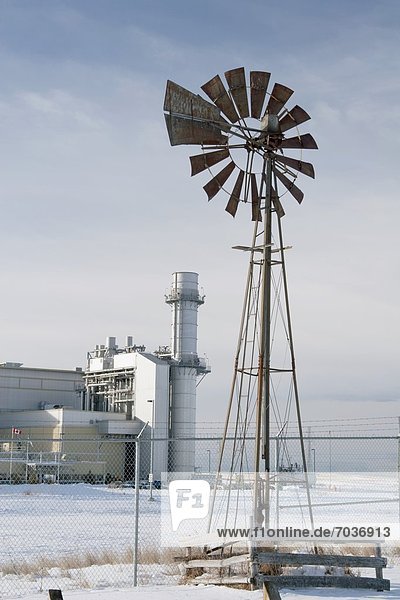 Windmill And Gas Plant In Winter