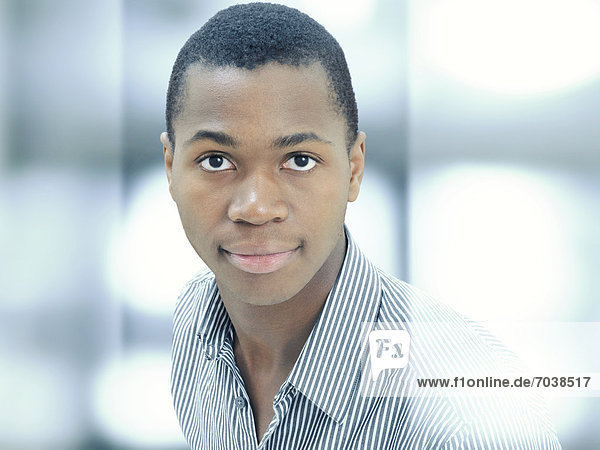 Young man  African-American  American  serious face  respectable  standing behind glass