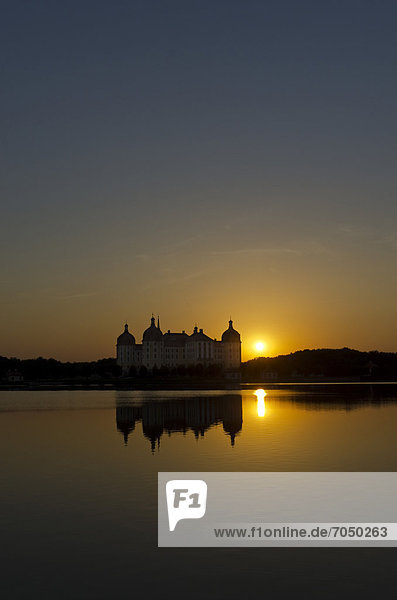 '''Schloss Moritzburg'' at sunset  a former castle to celebrate hunting  situated 10 km out of the City Dresden in the middle of beautiful forrests and lakes. Moritzburg   Germany'