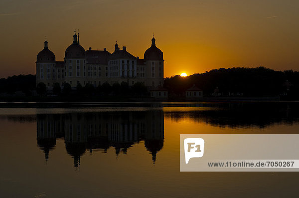 '''Schloss Moritzburg'' at sunset  a former castle to celebrate hunting  situated 10 km out of the City Dresden in the middle of beautiful forrests and lakes. Moritzburg   Germany'