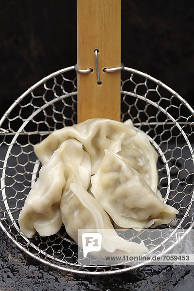 Asian dumplings in strainer