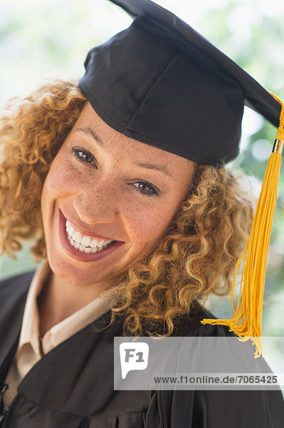 Portrait of smiling young woman in mortarboard