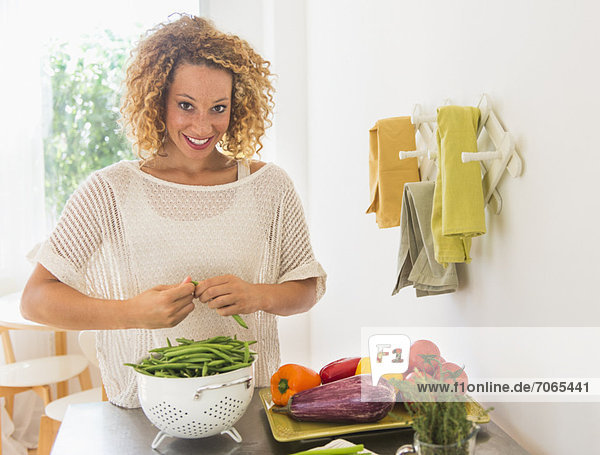 Young woman preparing food in kitchen