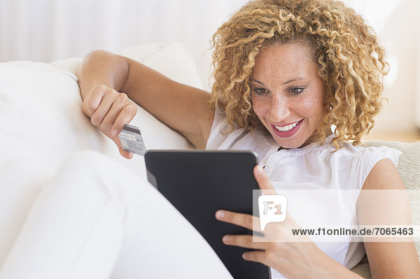 Young woman e-shopping with digital tablet