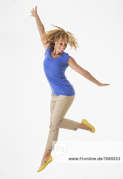 Woman jumping  studio shot