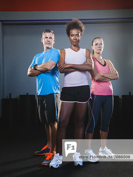 Portrait of three people in gym