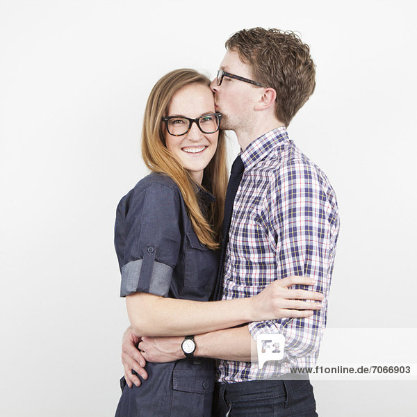 Studio Shot  portrait of young couple embracing