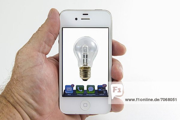 Light bulb on the screen of a smartphone  symbolic image for remote-controlled lights  mobile phone as a remote control