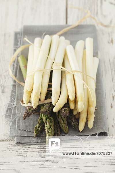 White and green asparagus on a cloth