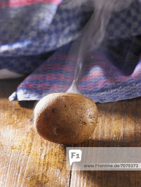 A whole steaming new potato