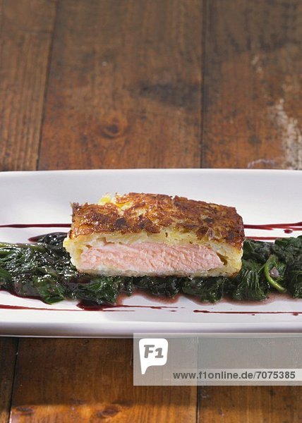Potato-wrapped salmon on a bed of spinach