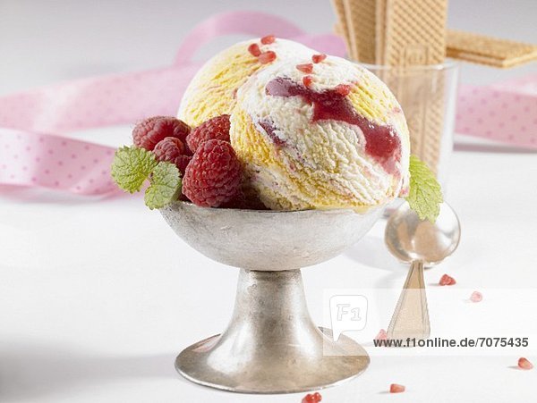 Marbled ice cream with fresh raspberries in an ice cream cup