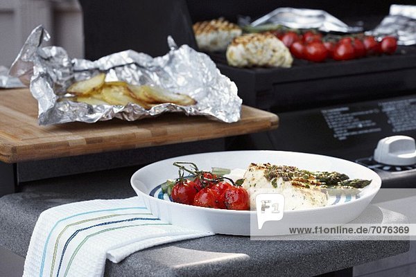 Grilled halibut with vine tomatoes and baked potatoes
