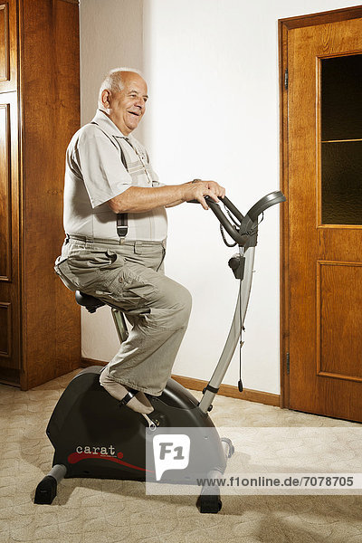 Elderly man sitting on an exercise bike
