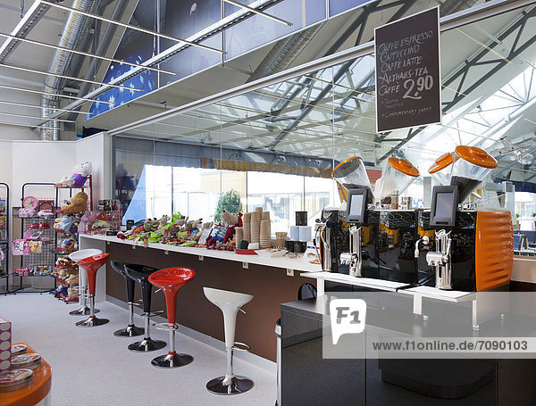 A long bar counter and coffee shop at Tallinn airport.