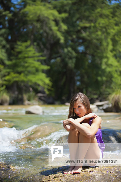 USA Texas Young woman sitting at Frio river