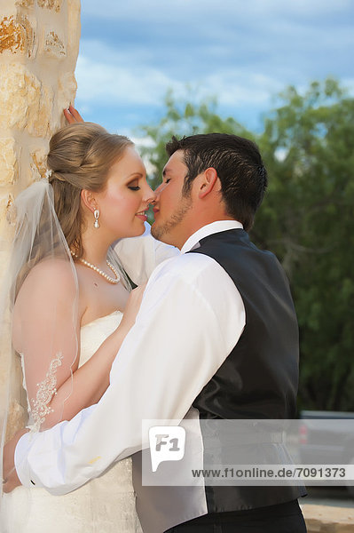 USA  Texas  Bride and groom romancing  close up