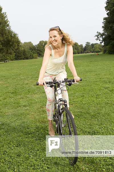 Young woman with her bicycle at Treptower Park