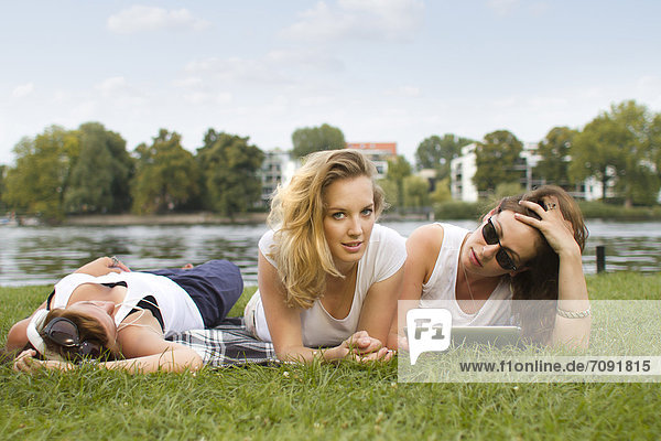 Germany,  Berlin,  Young students relaxing at Treptower Park