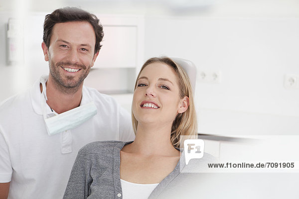 Germany  Dentist and patient in clinic  smiling