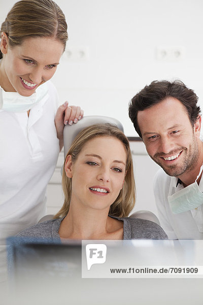 Germany  Dentist with patient viewing x ray