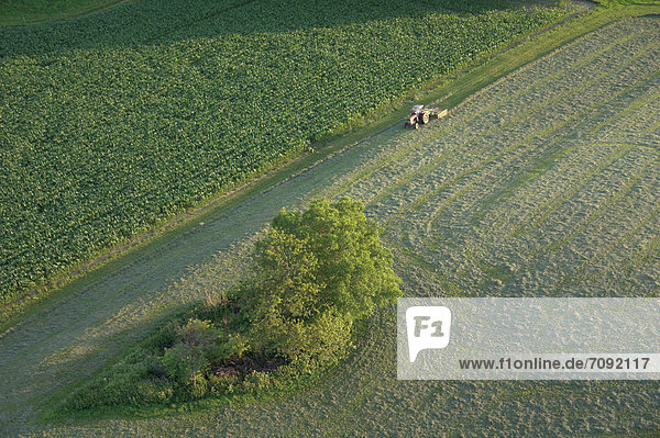 Germany  Bavaria  View of tractor with field and street