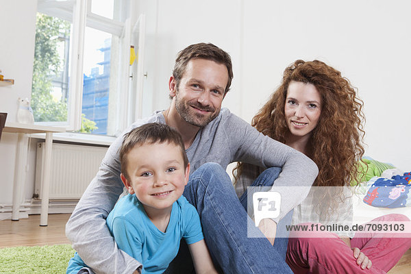 Germany  Berlin  Portrait of family at home  smiling