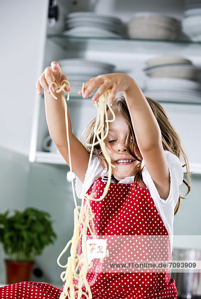 Germany  Girl playing with spaghetti
