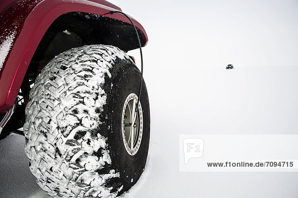 Balloon tyres Super Jeep in a winter landscape Vatnajoekull Glacier Icelandic Highlands Iceland Europe