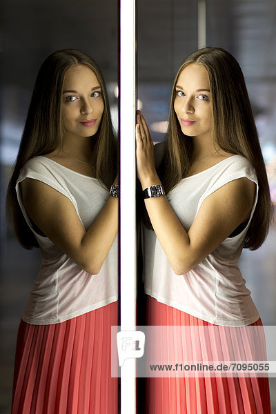 Young woman wearing a white top and a red skirt  mirror image