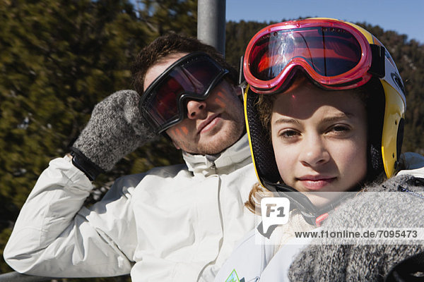 Brother and younger sister on chair lift  portrait
