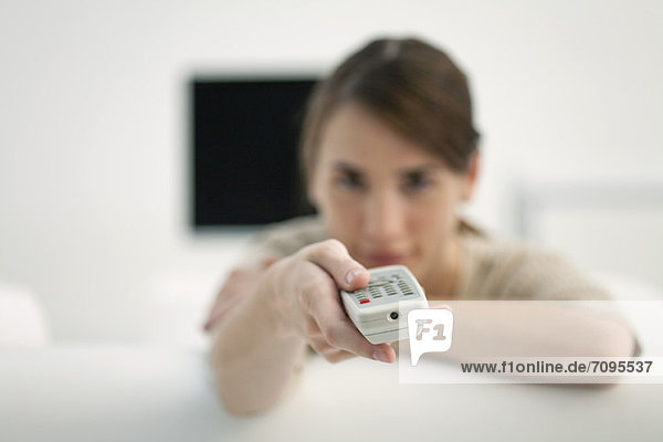 Woman holding out remote control