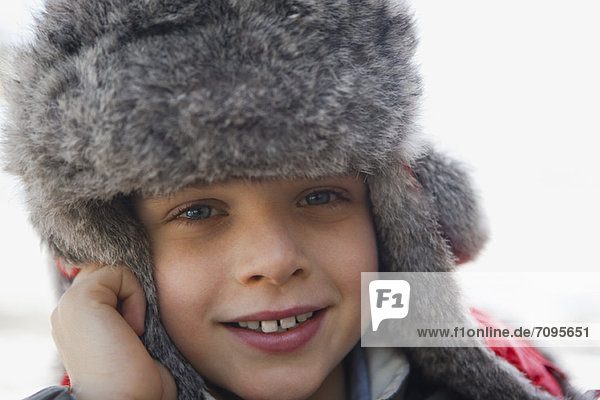 Boy wearing trappers hat  portrait  close-up