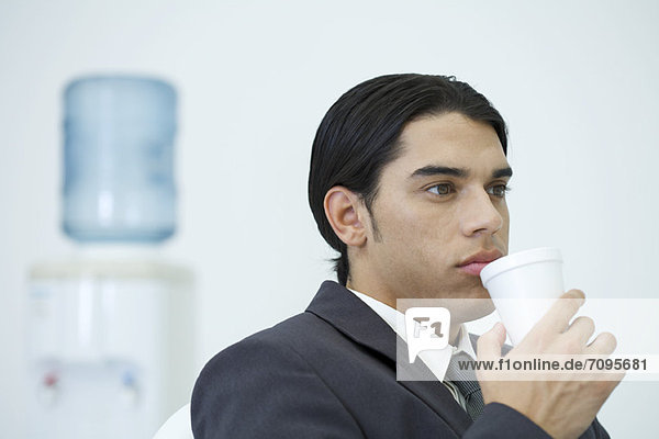 Young businessman taking a coffee break