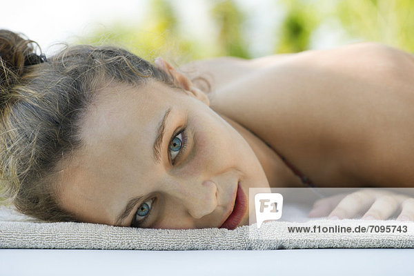 Young woman lying on towel  portrait