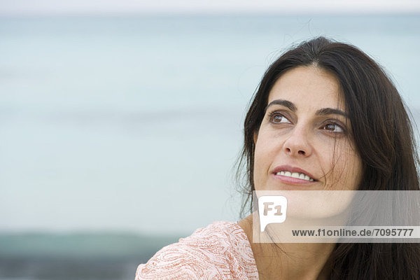 Mature woman looking up in thought  portrait