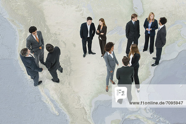 Executives chatting while standing on map of the United States