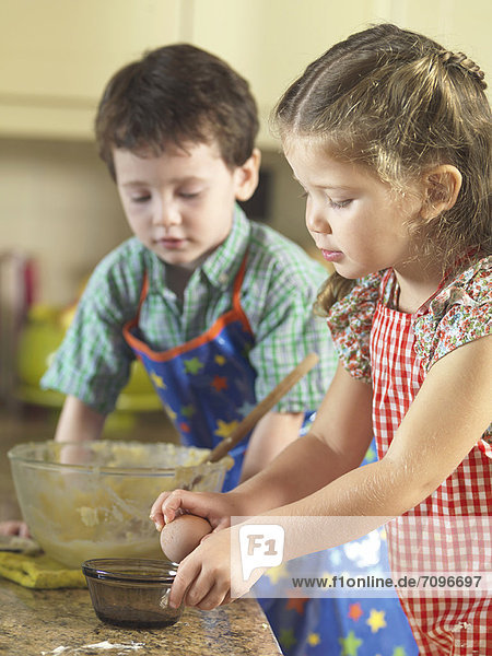 Children baking together in kitchen