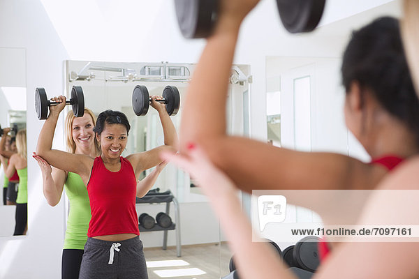 Woman working with trainer in gym