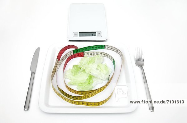 Plate with salad  scales and tape measure