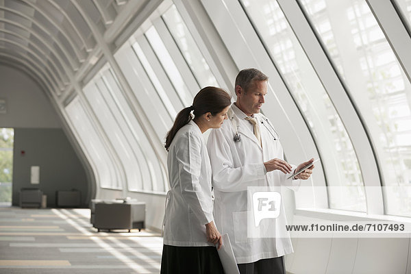 Doctors talking together in hospital corridor