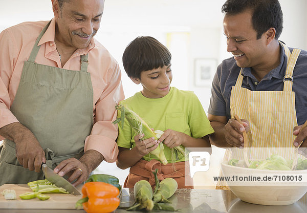 Hispanic grandfather  father and son preparing food
