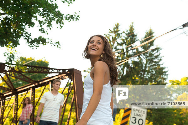 Teenage girl on bridge with friends